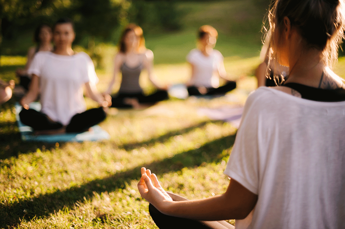 a recreational therapist leads an outdoor yoga class