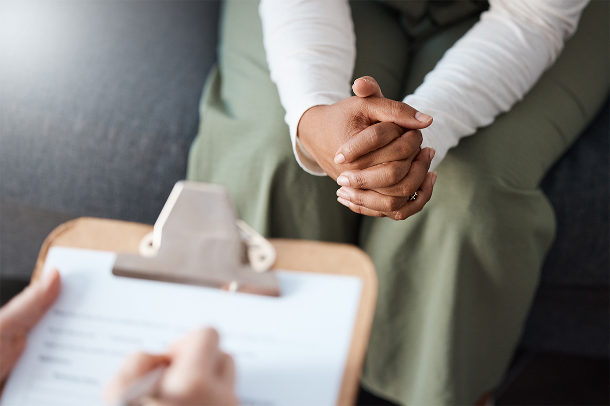 an outreach counselor takes notes while working with a client